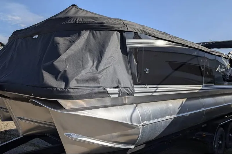 Slide: The Image of 2025 Avalon 2385 LSZ Cruise pontoon boat with black cover, side view. - 7