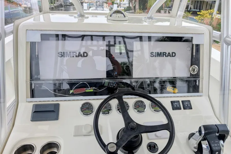 Slide: The Image of 2017 SeaVee 390Z boat dashboard with Simrad displays and steering wheel. - 5