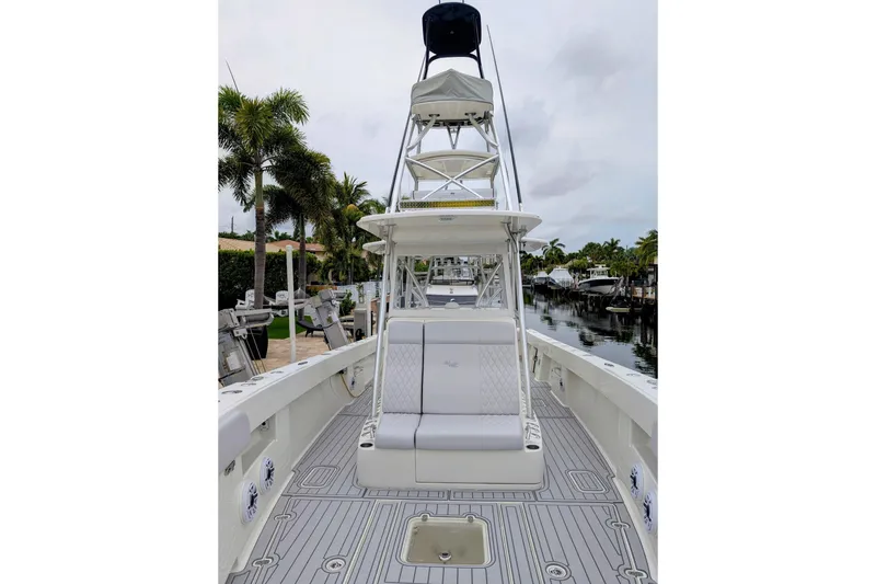 Slide: The Image of 2017 SeaVee 390Z boat with tower, docked near palm trees and canal. - 6