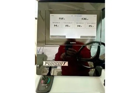 Slide: The Image of 2024 Pursuit DC 326 Dual Console dashboard with Garmin display and controls. - 10