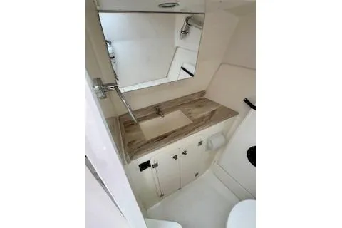 Slide: The Image of 2024 Pursuit DC 326 Dual Console bathroom with modern sink and mirror. - 14