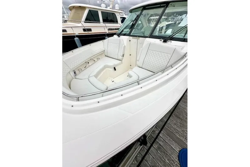 Slide: The Image of 2024 Pursuit DC 326 Dual Console boat with luxurious seating and sleek design. - 2