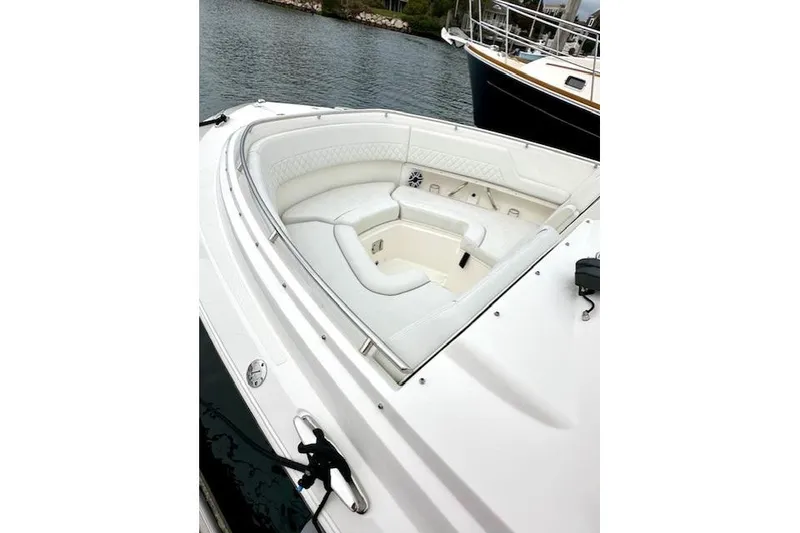 Slide: The Image of 2024 Pursuit DC 326 Dual Console boat with luxurious white seating in the bow area. - 3
