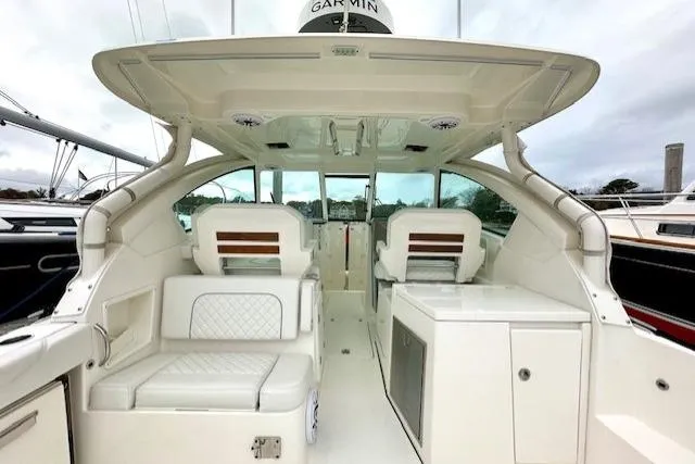 Slide: The Image of 2024 Pursuit DC 326 Dual Console boat interior with seating and helm, featuring modern design. - 5