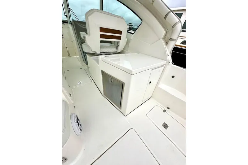 Slide: The Image of 2024 Pursuit DC 326 Dual Console interior with seating and storage. - 8