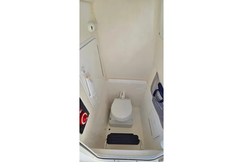 Slide: The Image of 2014 Regulator 25 boat interior with compact marine toilet. - 17