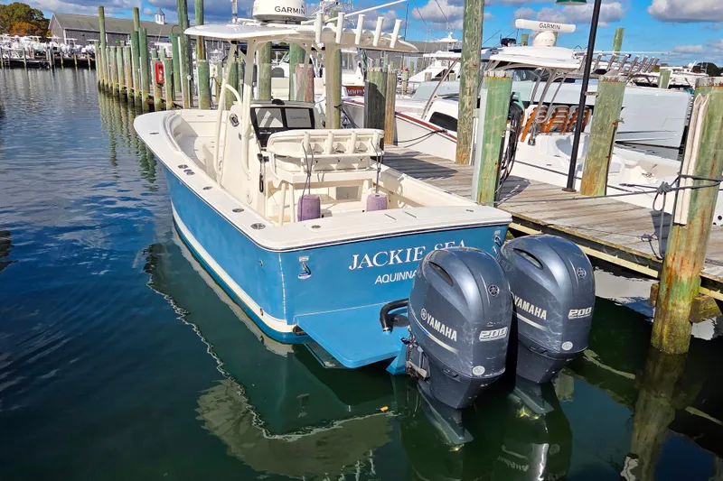 Slide: The Image of 2014 Regulator 25 boat docked with twin Yamaha engines. - 3