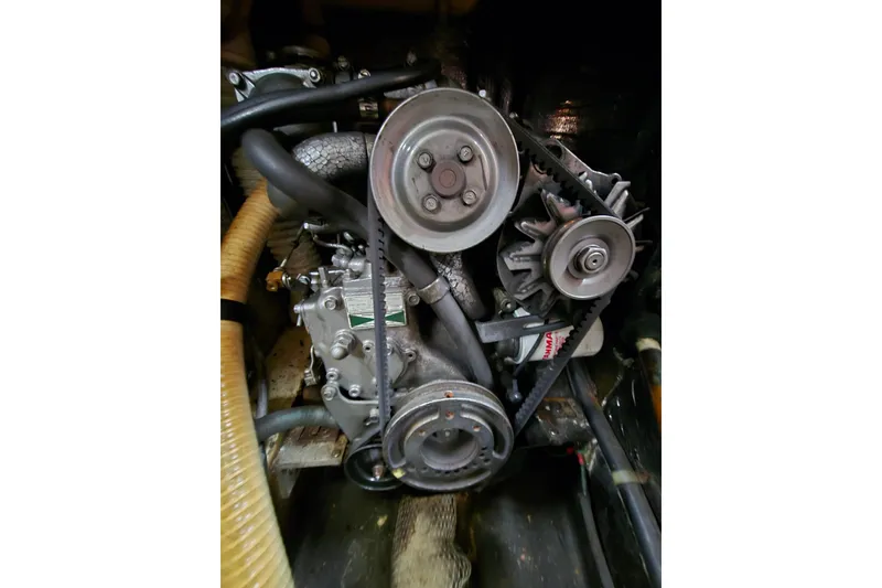 Slide: The Image of Engine of 1988 Pearson 365 Centerboard sailboat, showcasing belts and pulleys. - 19