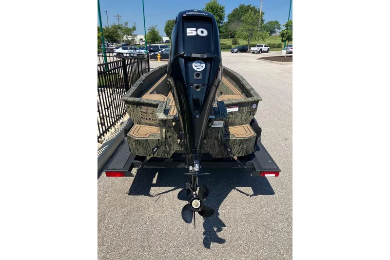 Slide: The Image of 2026 Tracker Grizzly 1650 T Prairie Wings Edition boat with 50 HP motor, parked outdoors. - 4