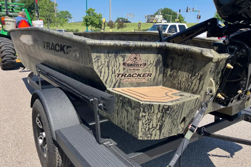Slide: The Image of 2026 Tracker Grizzly 1650 T Prairie Wings Edition boat on trailer, camo design. - 3