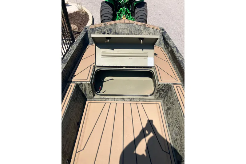 Slide: The Image of 2026 Tracker Grizzly 1650 T Prairie Wings Edition boat interior with storage compartments. - 7