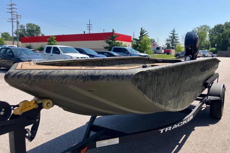 Slide: The Image of 2026 Tracker Grizzly 1650 T Prairie Wings Edition boat on trailer in parking lot. - 2