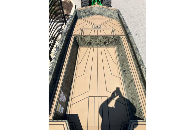 Slide: The Image of 2026 Tracker Grizzly 1650 T Prairie Wings Edition boat interior with camouflage design. - 8