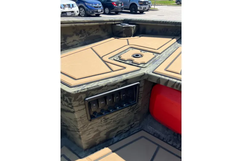Slide: The Image of 2026 Tracker Grizzly 1650 T Prairie Wings Edition boat interior with camouflage design. - 13