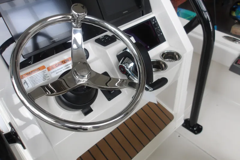 Slide: The Image of Steering console of 2026 Ranger 2510 Bay boat with modern controls and cup holders. - 15