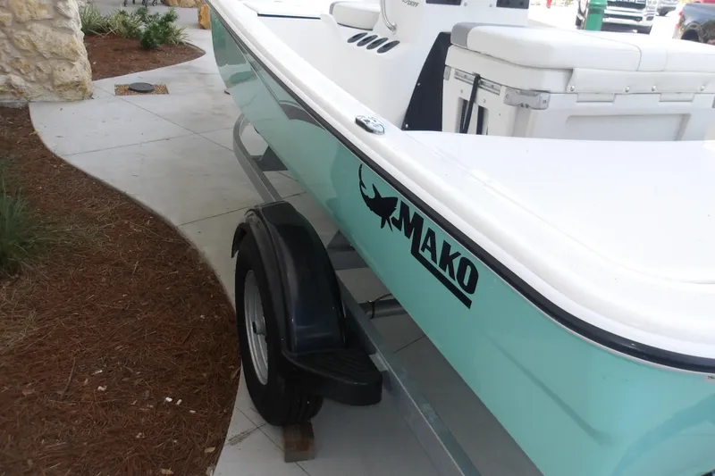 Slide: The Image of 2026 Mako Pro Skiff 15 CC boat on trailer, featuring sleek design and logo. - 60