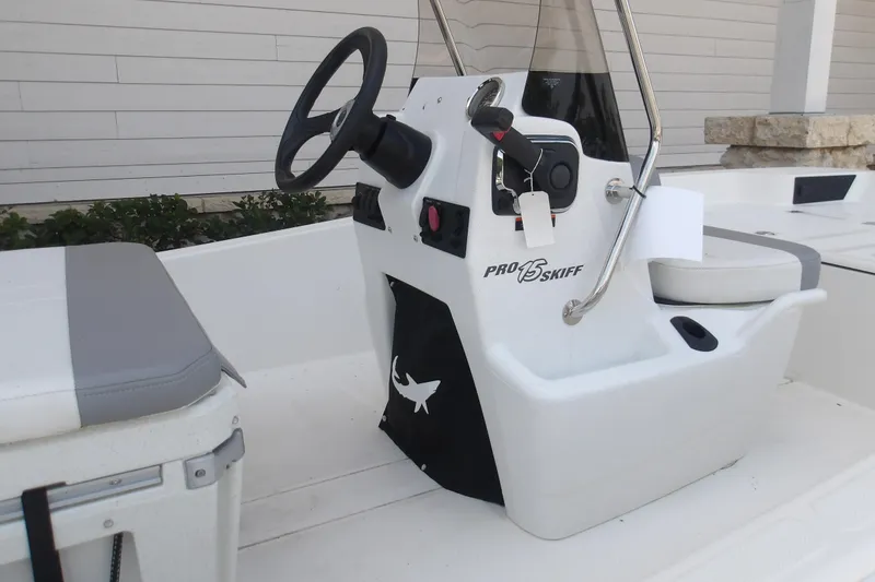 Slide: The Image of 2026 Mako Pro Skiff 15 CC boat interior with steering console and seating. - 62