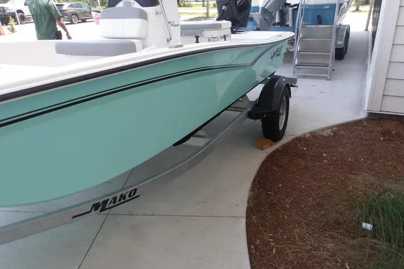 Slide: The Image of 2026 Mako Pro Skiff 15 CC boat on trailer, parked outdoors. - 64