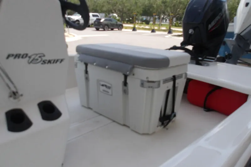 Slide: The Image of 2026 Mako Pro Skiff 15 CC boat interior with cooler and motor. - 69