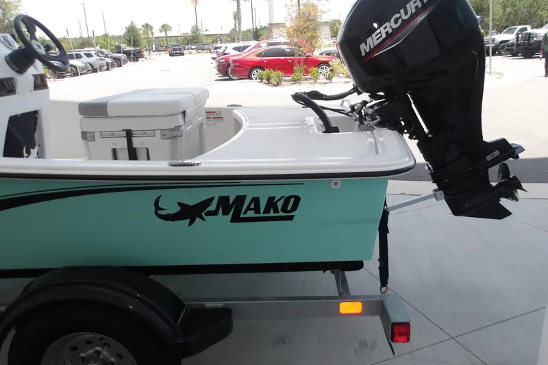 Slide: The Image of 2026 Mako Pro Skiff 15 CC boat with Mercury outboard motor on trailer. - 65