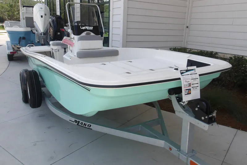 Slide: The Image of 2026 Mako Pro Skiff 15 CC boat on trailer, displayed outdoors. - 57