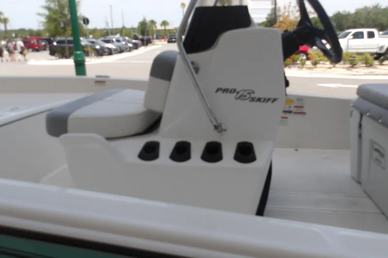 Slide: The Image of 2026 Mako Pro Skiff 15 CC boat interior with seating and steering console. - 68