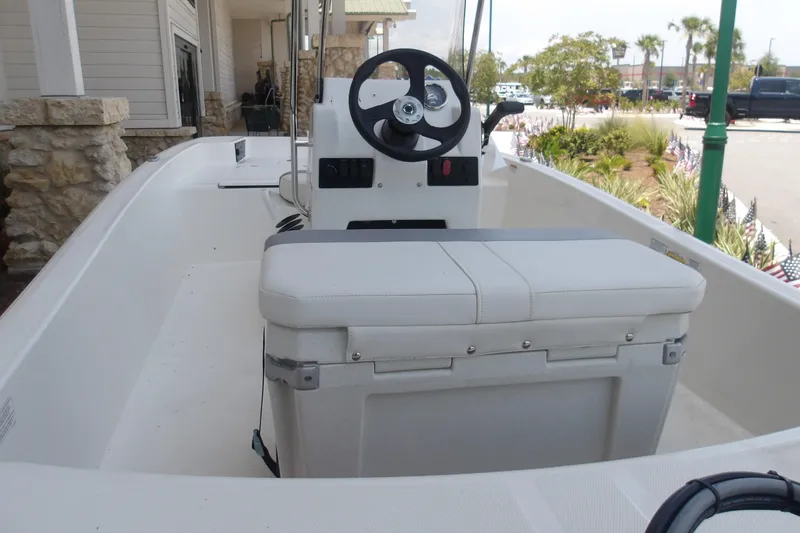 Slide: The Image of 2026 Mako Pro Skiff 15 CC boat interior with steering console and seating. - 61