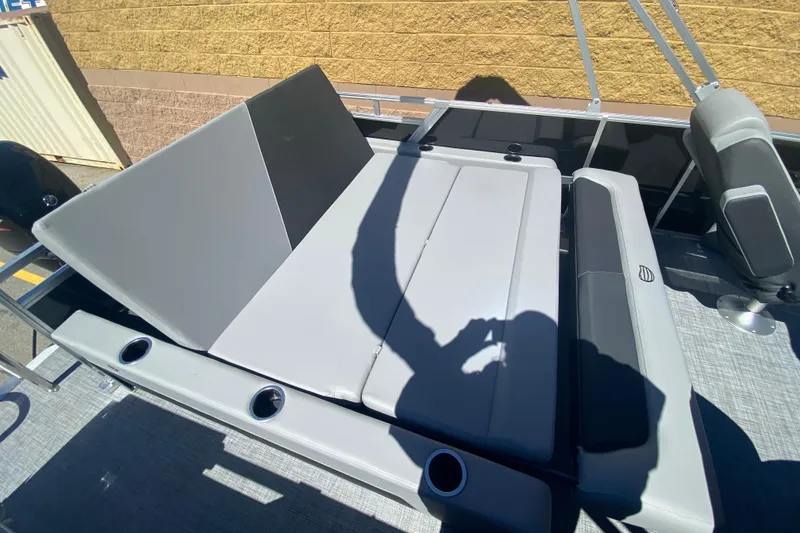 Slide: The Image of 2026 Sun Tracker Party Barge 22 RF DLX with gray seating and cup holders. - 12