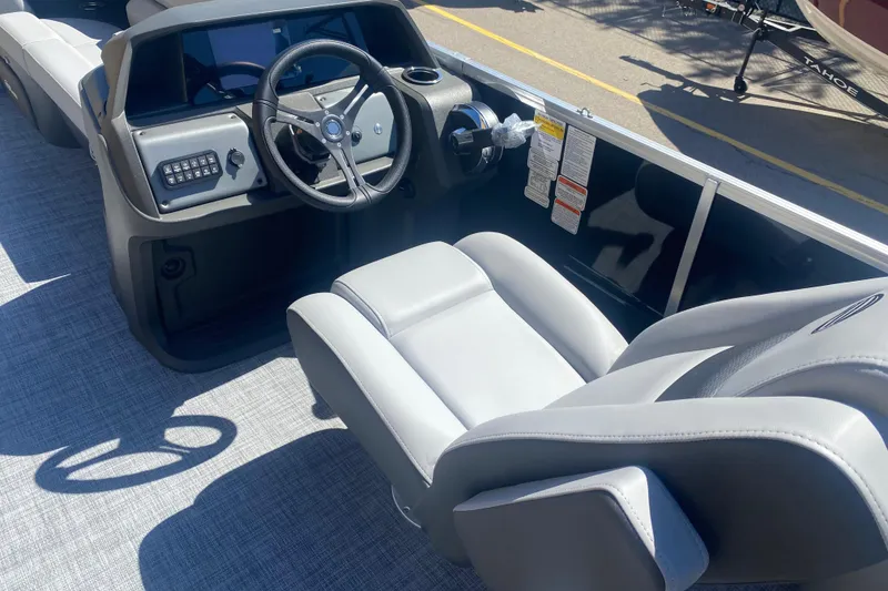 Slide: The Image of Interior view of 2026 Sun Tracker Party Barge 22 RF DLX with steering wheel and seating. - 9