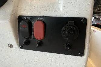 Slide: The Image of Control panel of 2026 Mako Pro Skiff 13 CC boat with switches and outlets. - 14