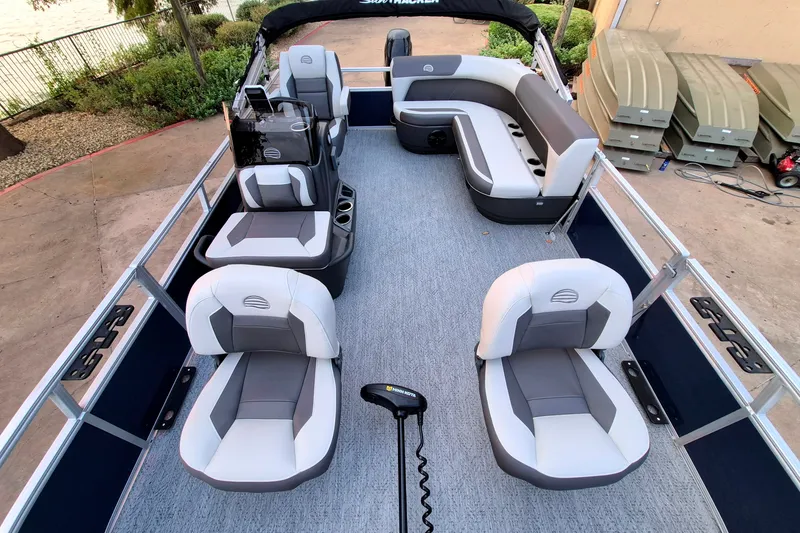 Slide: The Image of 2026 Sun Tracker Bass Buggy 16 XL Select pontoon boat interior with seating and helm. - 14