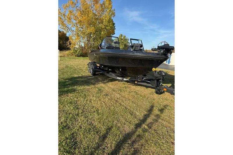 Slide: The Image of 2026 Nitro ZV20 Pro boat on trailer, parked on grassy area with autumn trees. - 69