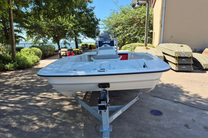 Slide: The Image of 2026 Mako Pro Skiff 17 CC boat on trailer, parked outdoors. - 2