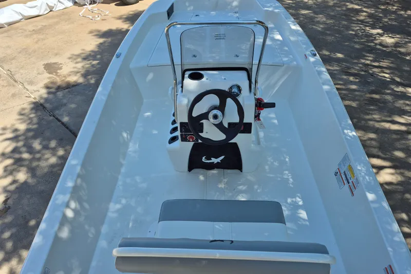 Slide: The Image of 2026 Mako Pro Skiff 17 CC boat interior with steering console and seating. - 8