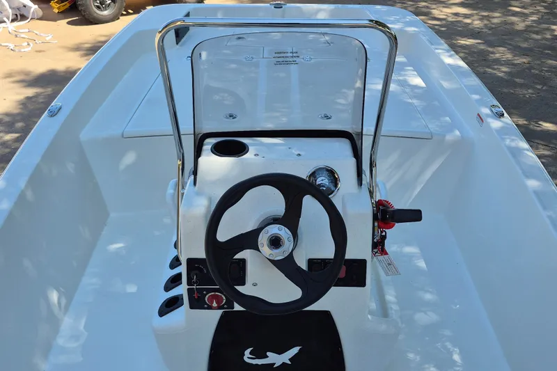 Slide: The Image of 2026 Mako Pro Skiff 17 CC boat interior with steering wheel and console. - 9