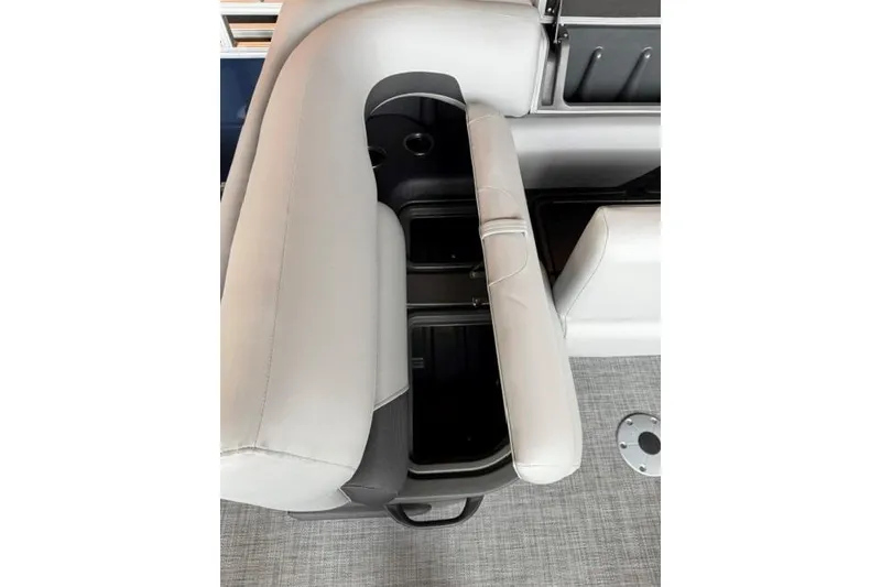 Slide: The Image of 2026 Sun Tracker SportFish 22 XP3 boat interior with storage compartment and cup holders. - 12