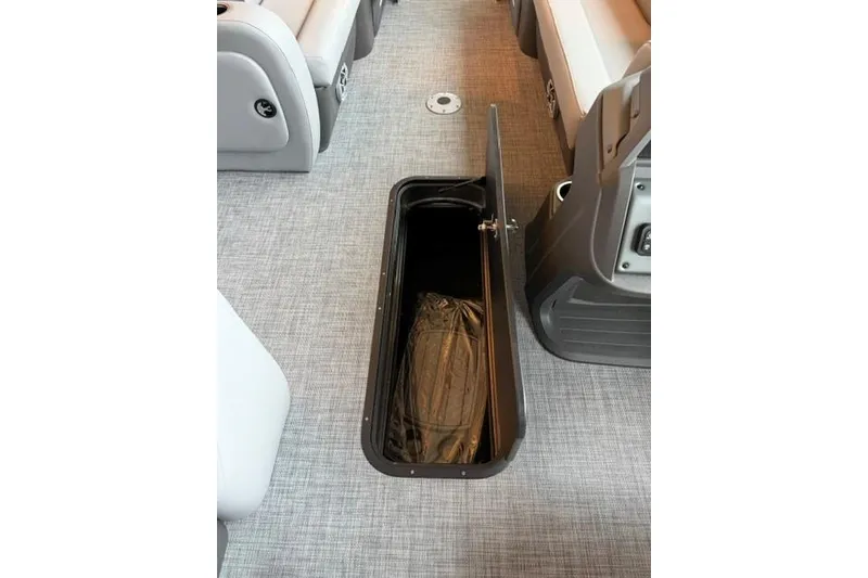 Slide: The Image of 2026 Sun Tracker SportFish 22 XP3 boat interior with open storage compartment. - 13