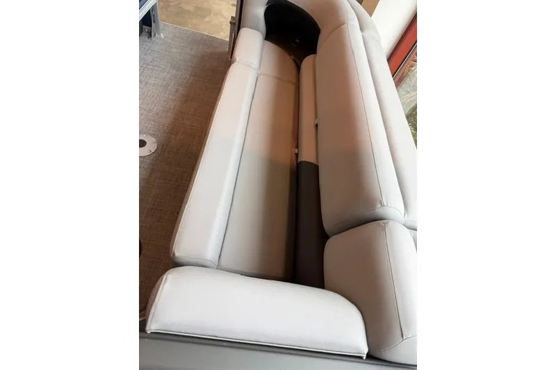 Slide: The Image of Interior seating of 2026 Sun Tracker SportFish 22 XP3 boat, featuring plush gray upholstery. - 8