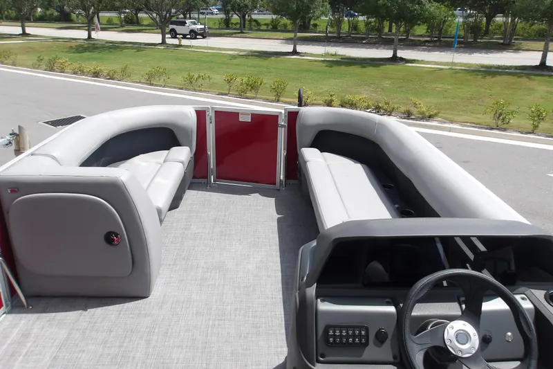 Slide: The Image of 2026 Sun Tracker Party Barge 18 DLX interior with spacious seating and modern helm. - 14