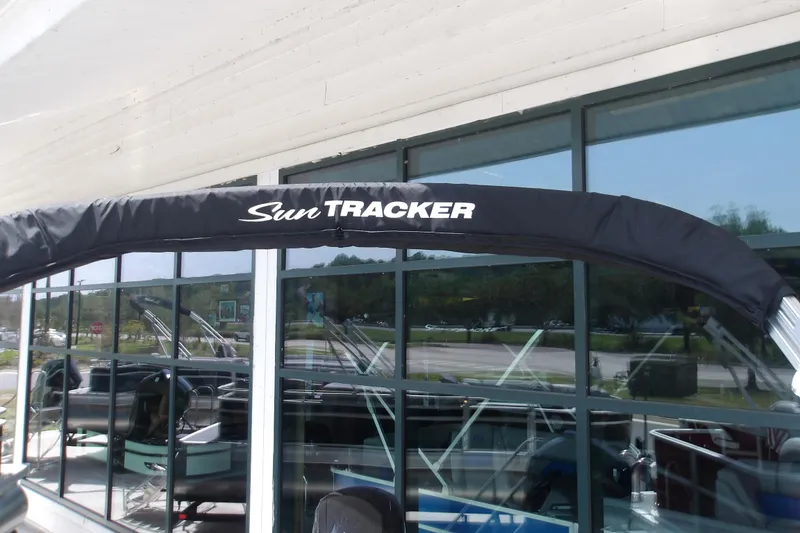 Slide: The Image of 2026 Sun Tracker Party Barge 18 DLX pontoon boat with canopy, displayed outdoors. - 13