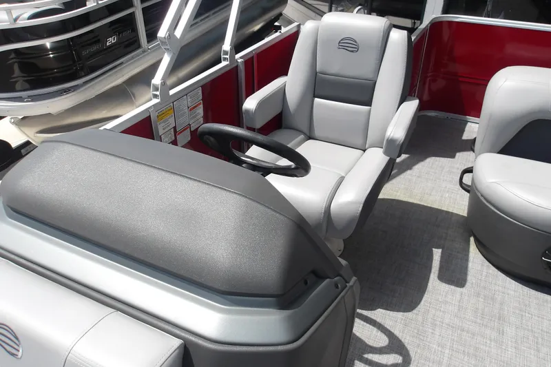 Slide: The Image of 2026 Sun Tracker Party Barge 18 DLX interior with steering wheel and seating. - 17