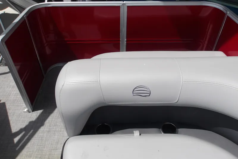 Slide: The Image of 2026 Sun Tracker Party Barge 18 DLX interior with red paneling and gray seating. - 15