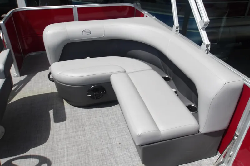 Slide: The Image of 2026 Sun Tracker Party Barge 18 DLX interior with gray seating and cup holders. - 16