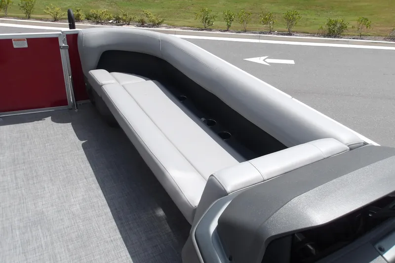 Slide: The Image of 2026 Sun Tracker Party Barge 18 DLX interior with gray seating and cup holders. - 19
