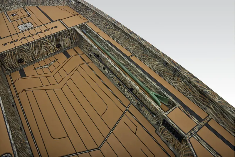 Slide: The Image of 2026 Tracker Grizzly 1756 T Marsh boat interior with camo design and tan flooring. - 18