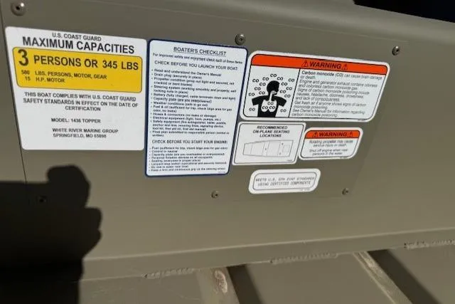 Slide: The Image of 2026 Tracker Grizzly 14 Jon boat safety and capacity labels, including U.S. Coast Guard guidelines. - 5
