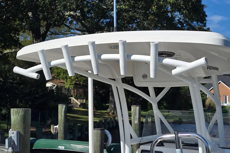 Slide: The Image of 2022 Sea Fox 249 Avenger boat with rod holders, docked near a residential area. - 15