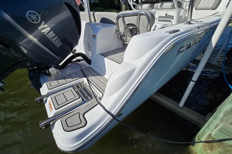 Slide: The Image of 2022 Sea Fox 249 Avenger boat with Yamaha engine, docked, featuring swim platform and ladder. - 16