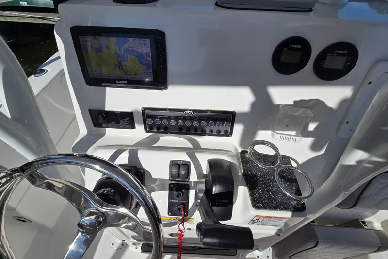 Slide: The Image of 2022 Sea Fox 249 Avenger dashboard with Garmin GPS, Yamaha controls, and cup holders. - 25