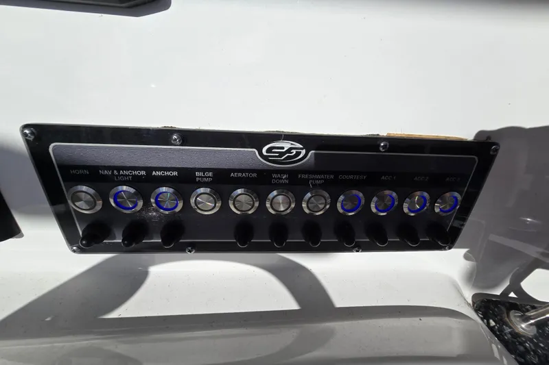 Slide: The Image of Control panel of 2022 Sea Fox 249 Avenger boat with labeled switches and buttons. - 28